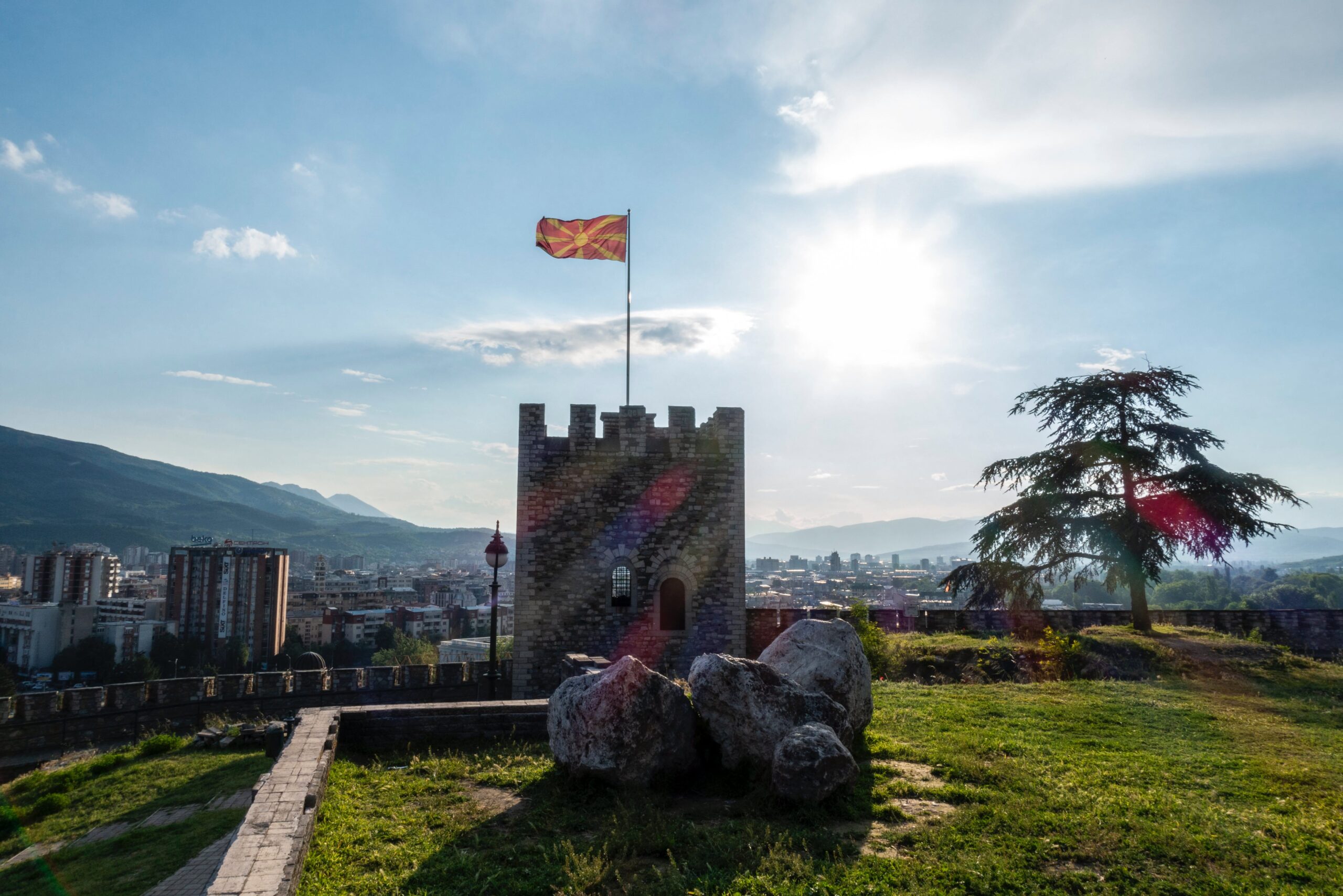 The flag of North Macedonia flying over the capital of Skopje