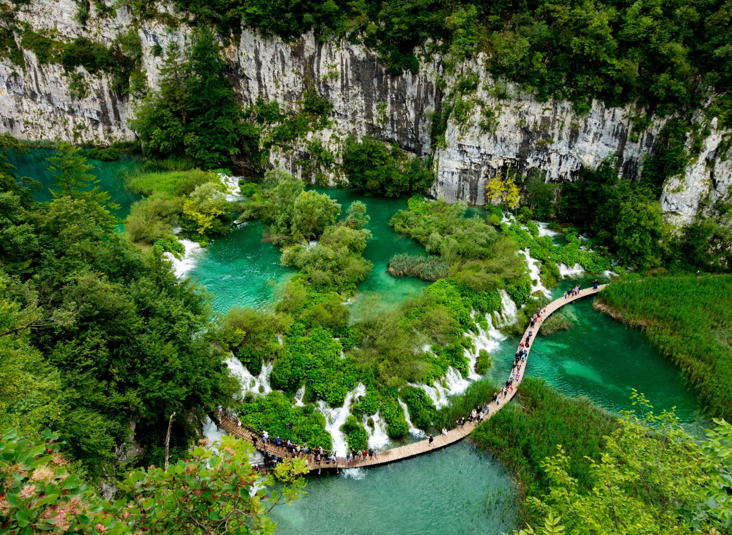 Tourists walking around the beautiful Plitvice Lakes National Park located in Croatia
